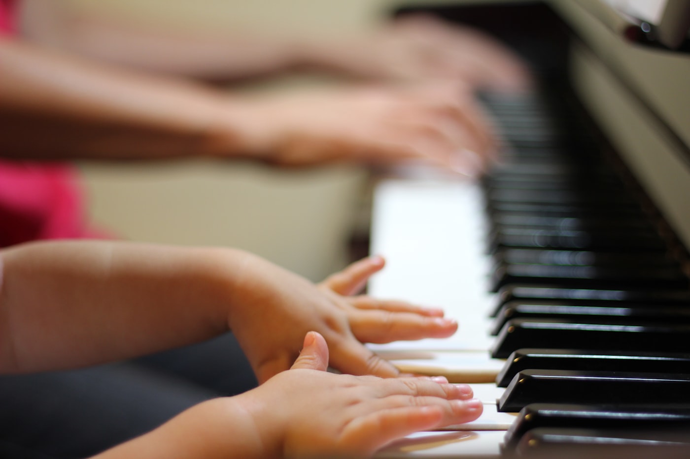 One-on-one piano lesson, hands on the keys