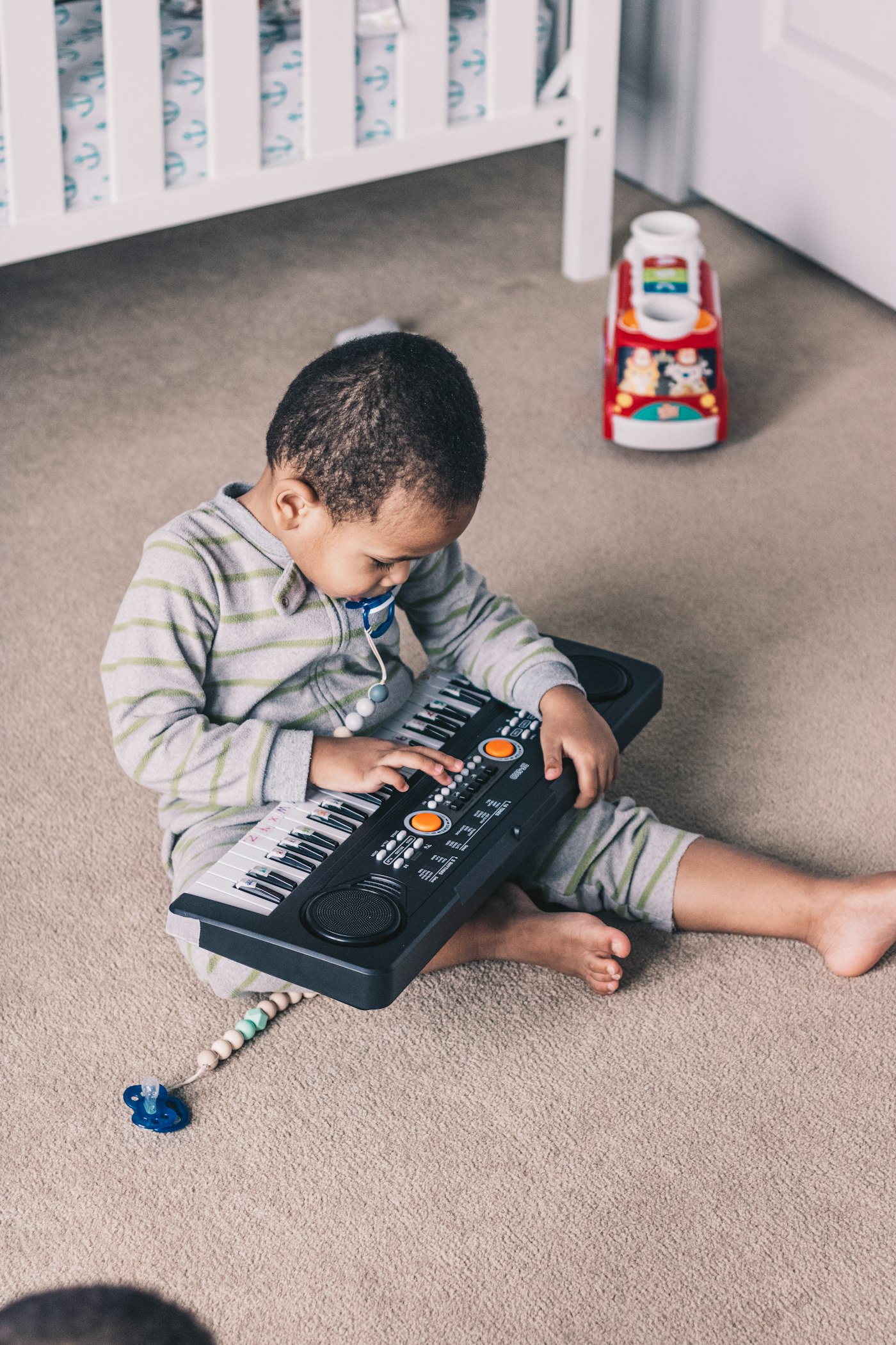 Toddler exploring a mini keyboard
